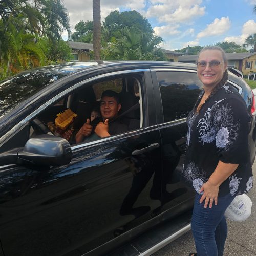 Dad and Daughter feed the block Love Serves turkey