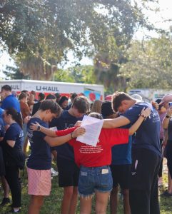 Family praying feed the block Love Serves Feed The Block HomesUnited Ministries (5)