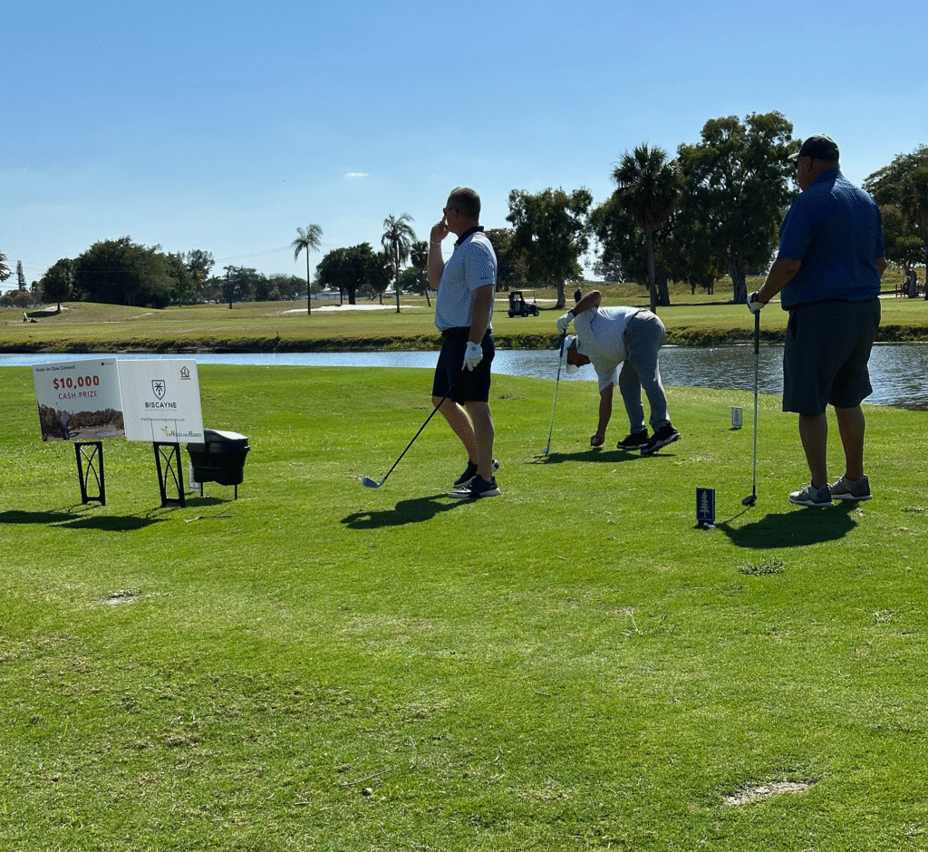 HomesUnited Ministries Donor Sponors playing golf on the green hole in one Prizes